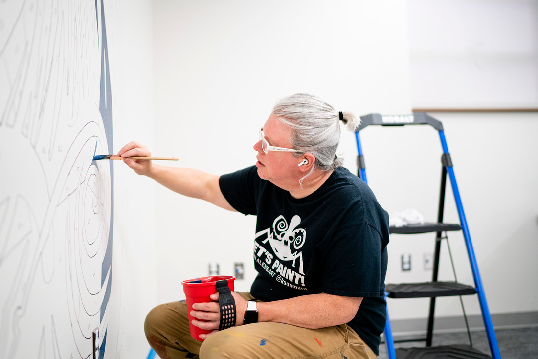 UAFS graphic design professor Bryan Alexis paints mural inside the UAFS Writing Center