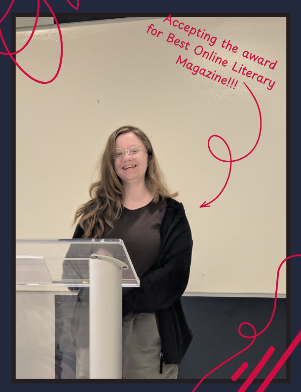 A smiling student editor stands behind a clear podium while accepting an award. The image is framed with dark borders and bright pink decorative swirls. Pink text near the top reads, “Accepting the award for Best Online Literary Magazine!!!” with an arrow pointing toward the speaker.
