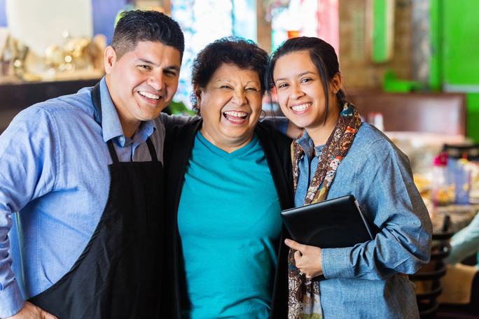 Mother, son and daughter smiling as a family business