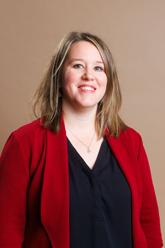 Amanda Seidenzahl wears a red blazer and black shirt during a professional photo shoot