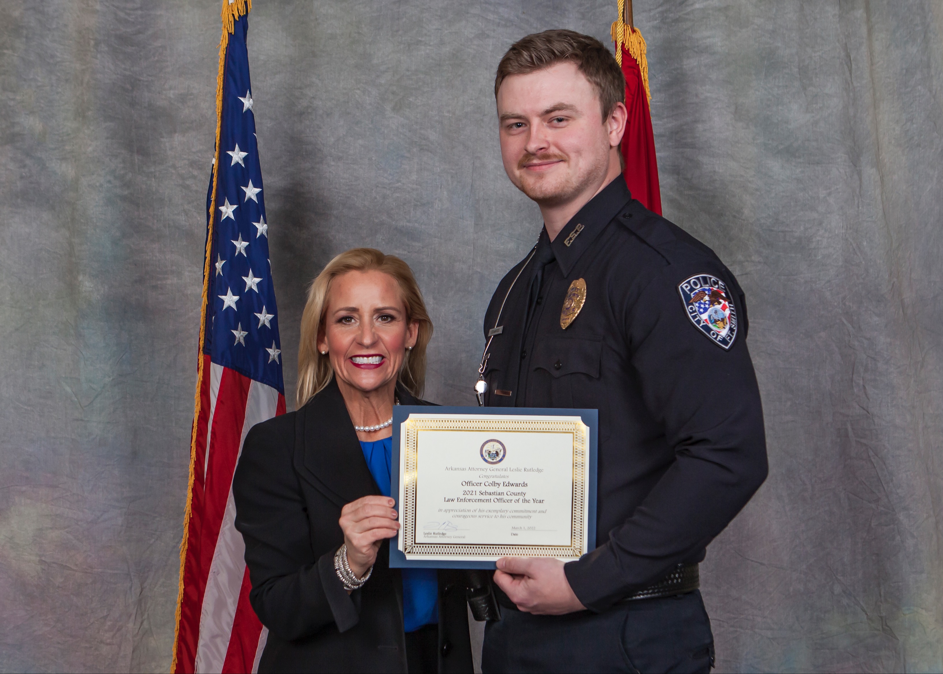 Officer Colby Edwards recieves the 2021 Sebastian County Law Enforcement Officer of the Year Award from Arkansas Attorney General Leslie Rutledge.