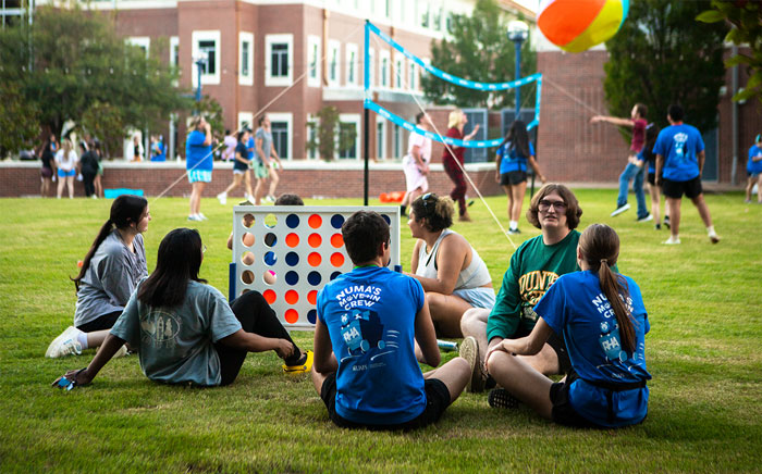 UAFS students gather around a yard-game of Connect Four in the Lion's Den Courtyard 