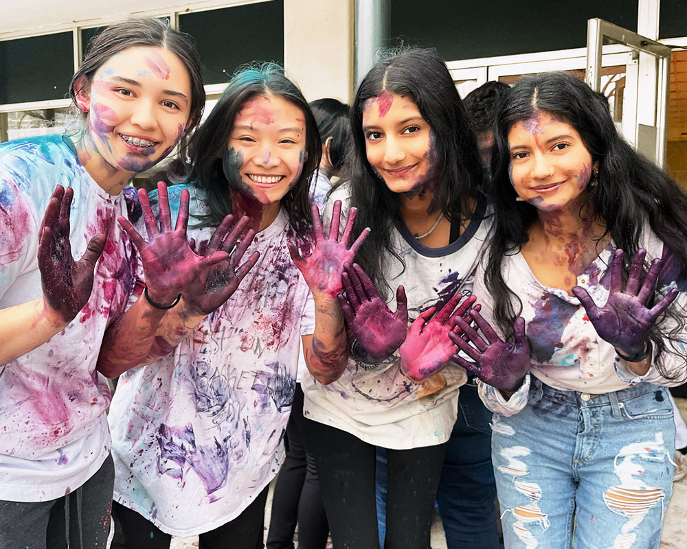 Hands covered in paint during Holi celebration at UAFS
