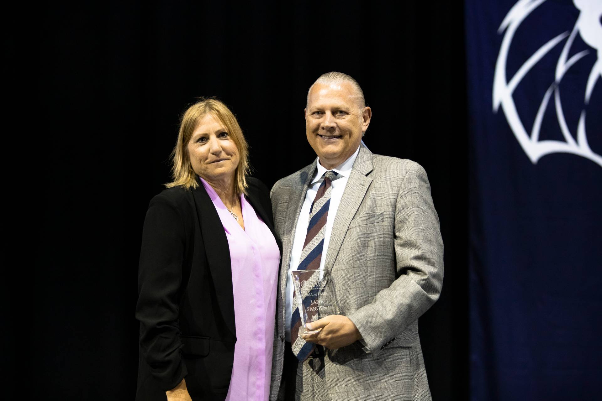 Jane Sargent accepts UAFS Hall of Fame award from Curtis Janz