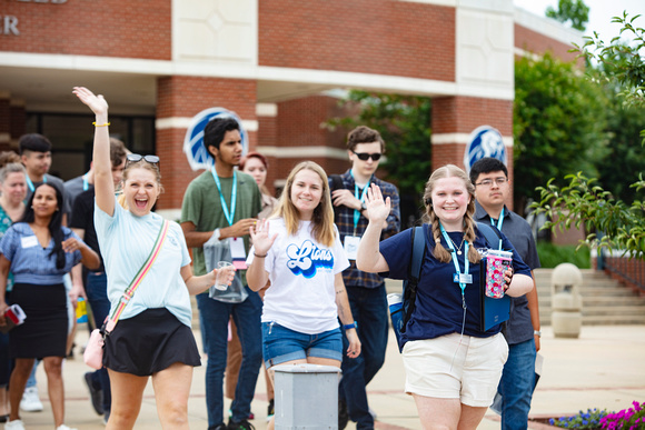Students wave to the camera during Mane Event at UAFS