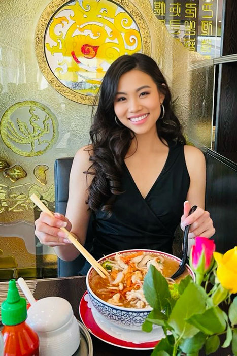 Quynh Nguyen eating a bowl of food