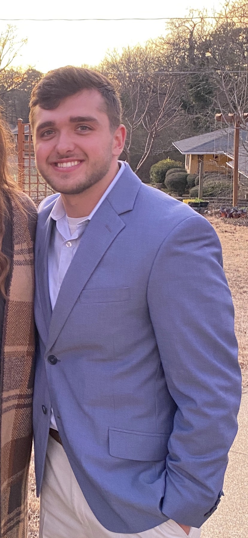 William psoing for a photo in a suit jacket.