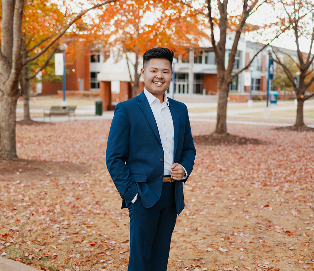 Braden Nguyen, a senior psychology student at UAFS poses in front of the Boreham Library