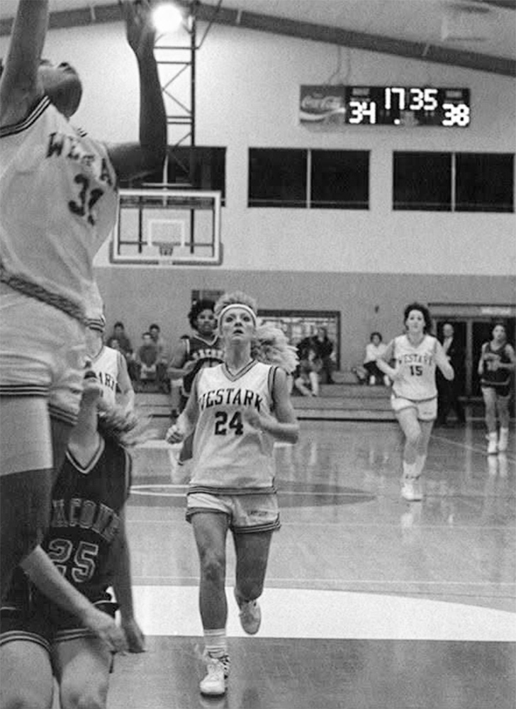 Brenda Fredriksen, 24, runs down the court to assist her teammate during a close basketball game.