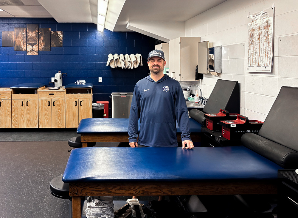 Brian O'Connor, director of sports medicine, stands behind one of the exam tables in the UAFS Athletics' Training Room.