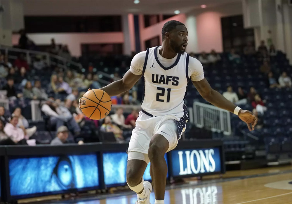 Jarren McAllister dribbles down the court at Stubblefield Arena during a UAFS men's basketball game.