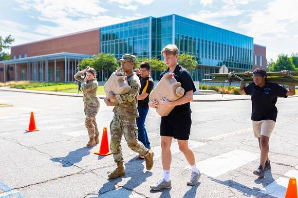 ROTC students carry supplies