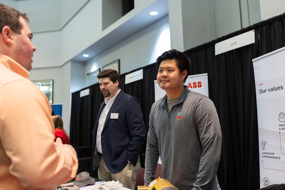 A student talks with representatives from ABB during an All Majors Career Fair at UAFS
