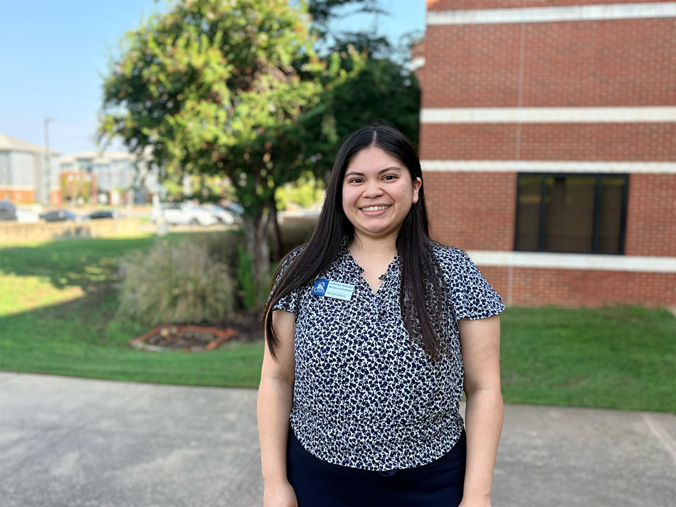 Catherine González, TRIO Upward Bound coordinator smiles outside of the Echols Building at UAFS.