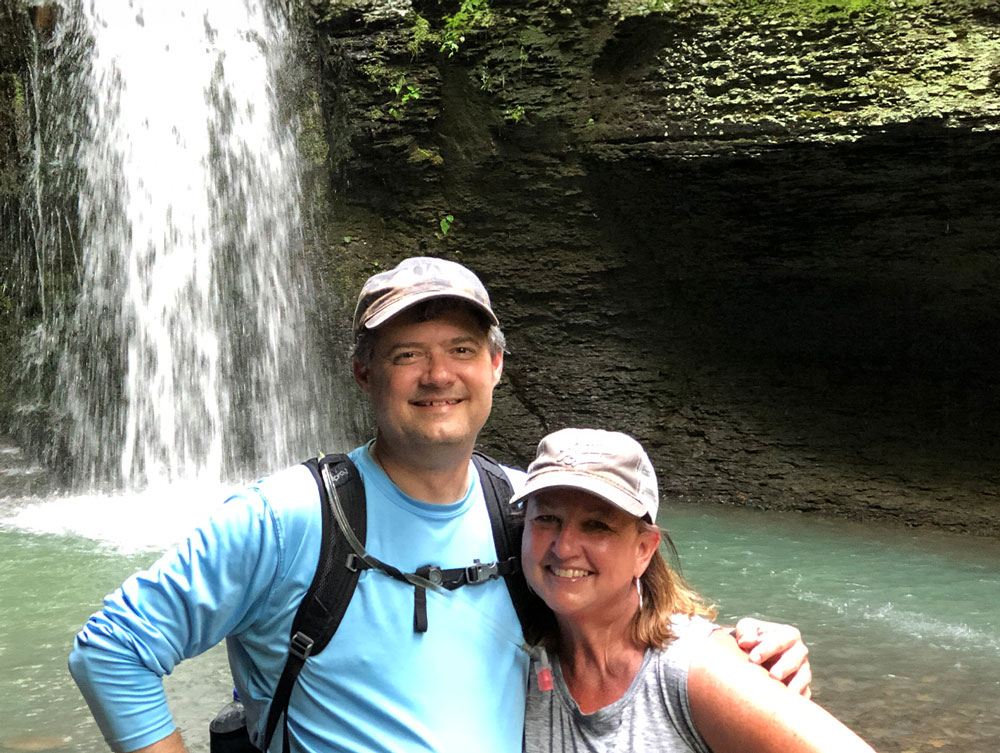 Chris and his fiance Kathy pose in front of a waterfall during one of their many hikes through Arkansas