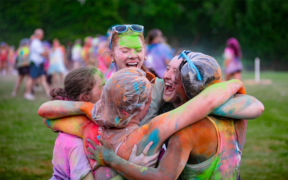 Students share a group hug at the Cup Camp Color War