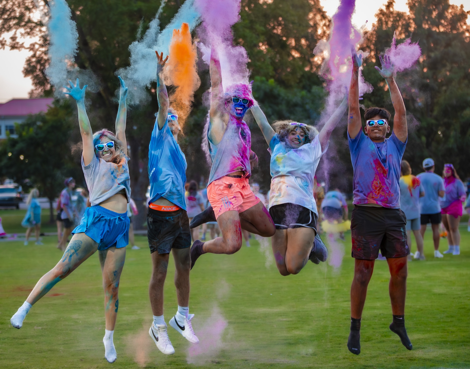 students throw colored paint at cub camp