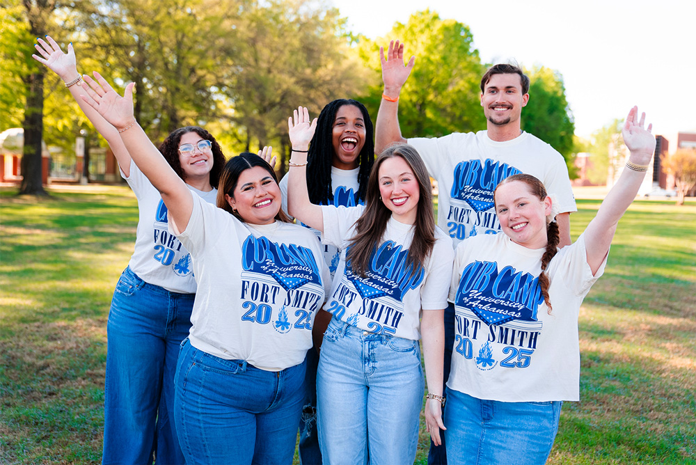Members of the Cub Camp D-Staff and C-Staff wave for a photo on the UAFS Campus Green.