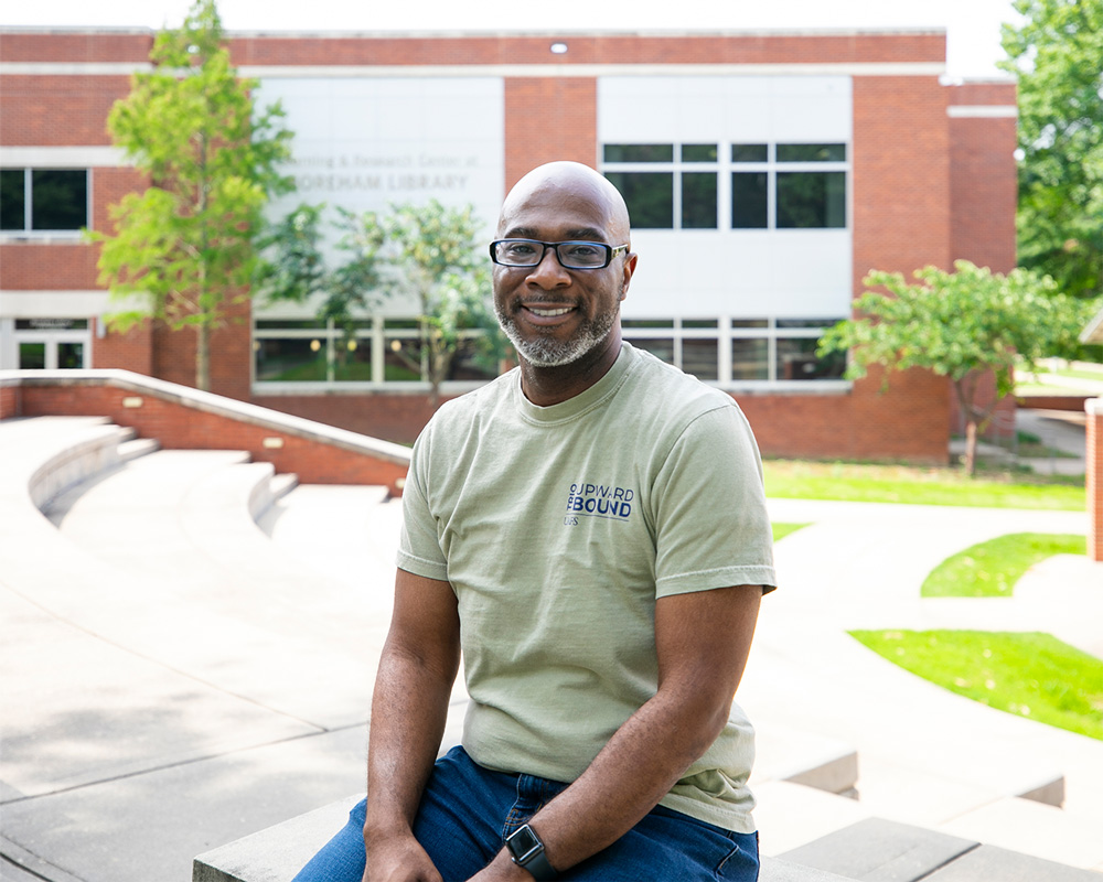 DeJon Jordan, assistant director for TRIO STEM at UAFS, smiles for the camera outside of the Boreham Library