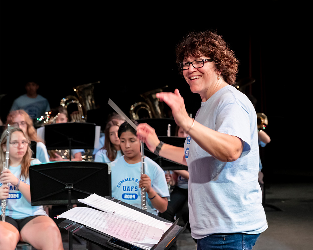 Dr. Alexandra Zacharella conducts students during a summer band camp
