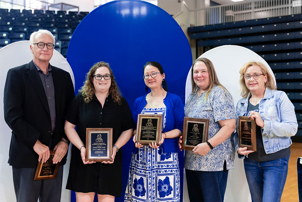 From left to right: Tom Watkins, Dr. Jordan Mader, Dr. Ann-Gee Lee, Roberta Parks, and Dr. Virginia Hardgraves accept their faculty awards.