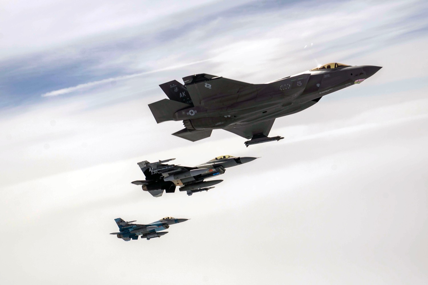 An F-35A Lightning II and two F-16 Fighting Falcons, assigned to Eielson Air Force Base, Alaska, fly above the Joint Pacific Alaska Range Complex, July 28, 2021. The aircraft participated in air refueling with an Alaska Air National Guard KC-135R Stratotanker. (U.S. Air Force photo by Staff Sgt. Kaylee Dubois)