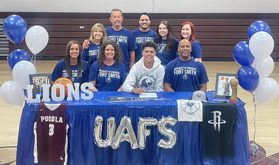 Garrett Scott is surrounded by family and friends as he signs his National Letter of Intent to play basketball for the University of Arkansas - Fort Smith