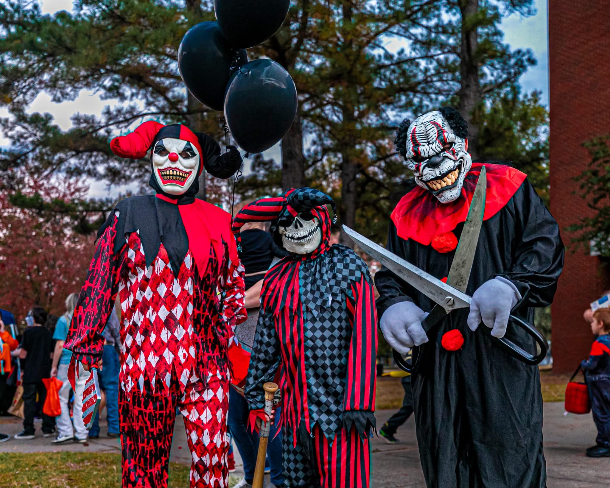 A family in scary clown costumes poses at Haunted University