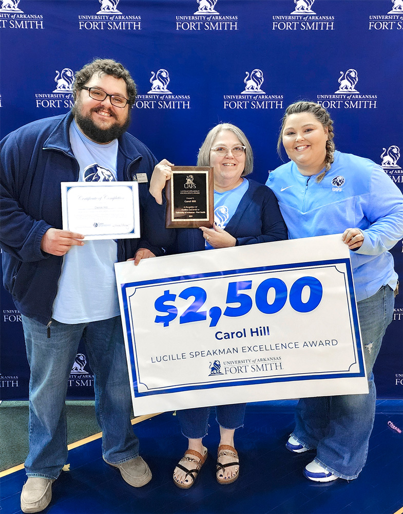 Carol Hill, center, accepts the Lucille Speakman Excellence Award with her son, Derek, and daughter, CarolAnn
