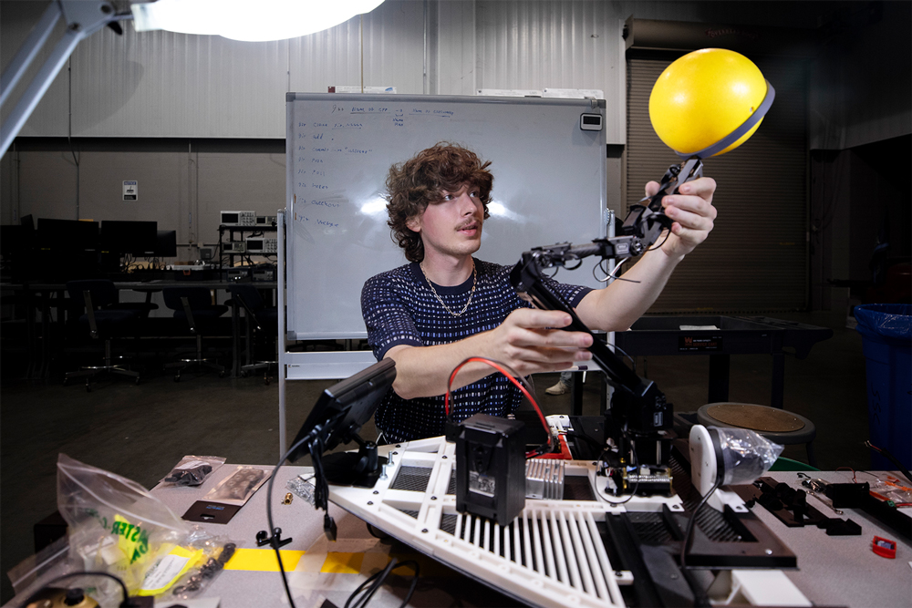 Hudson Reeves works on an autonomous vehicle and its ability to hold a yellow ball