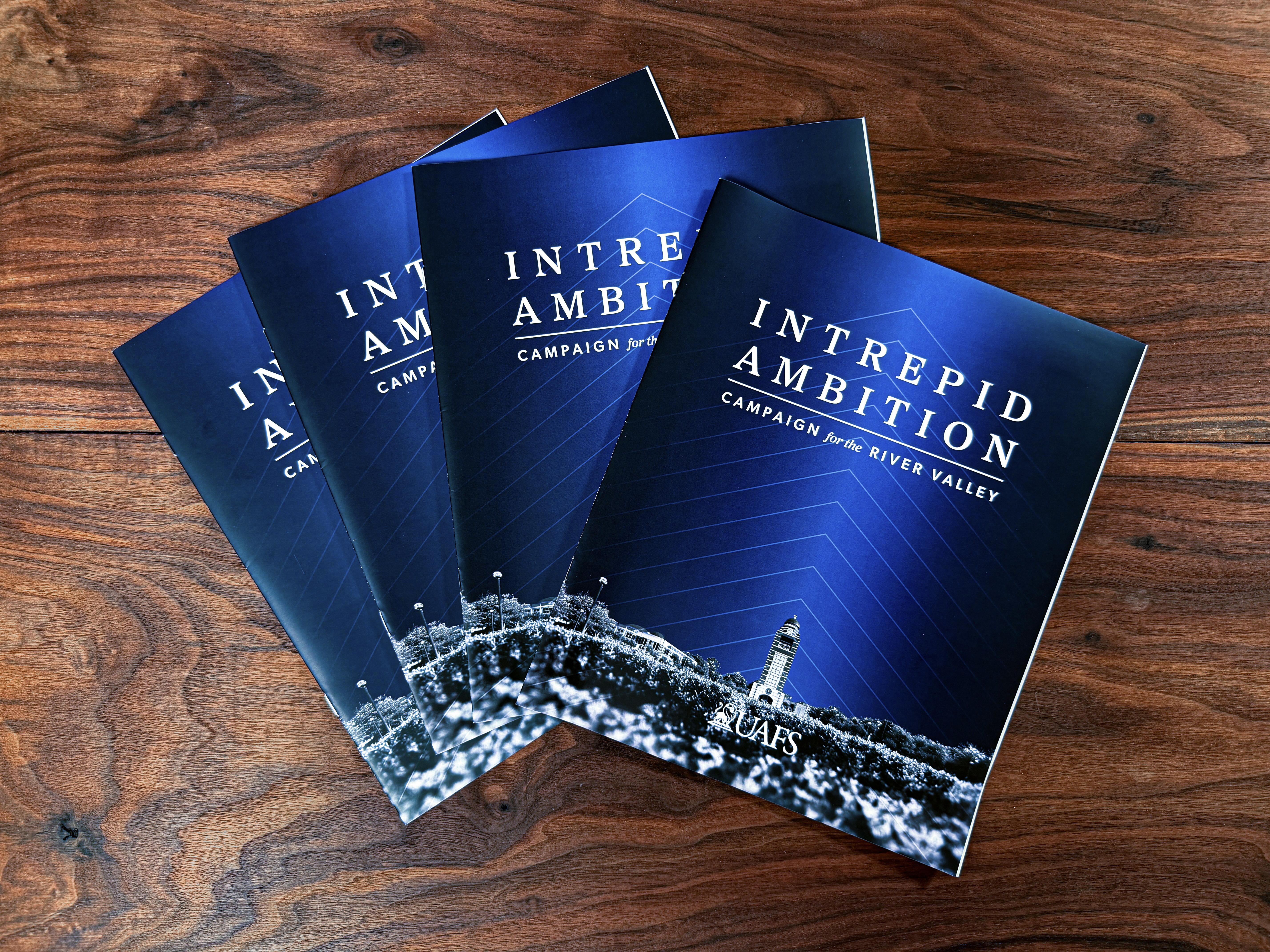 intrepid ambition magazines are displayed on a table.