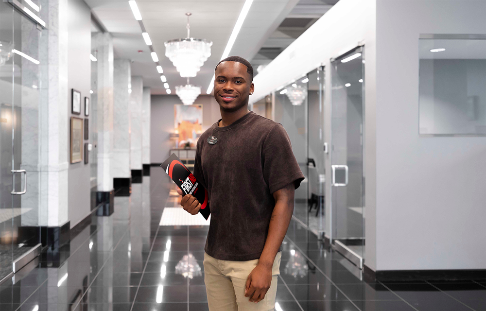 Jayden Robinson stands in a hallway of First National Bank in Fort Smith where he works