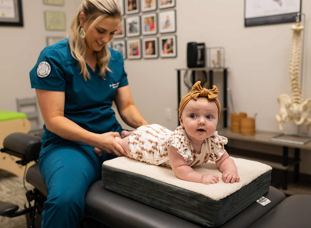 Dr. Jordana Beutelschies, '10, adjusts an infant at her chiropractic office, JB Family & Animal Chiropractic, in Van Buren