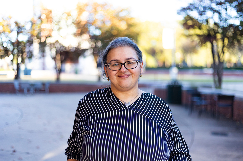 UAFS associate professor of mathematics, Dr. Kayla Murray, smiles for the camera outside of the Smith-Pendergraft Campus Center.