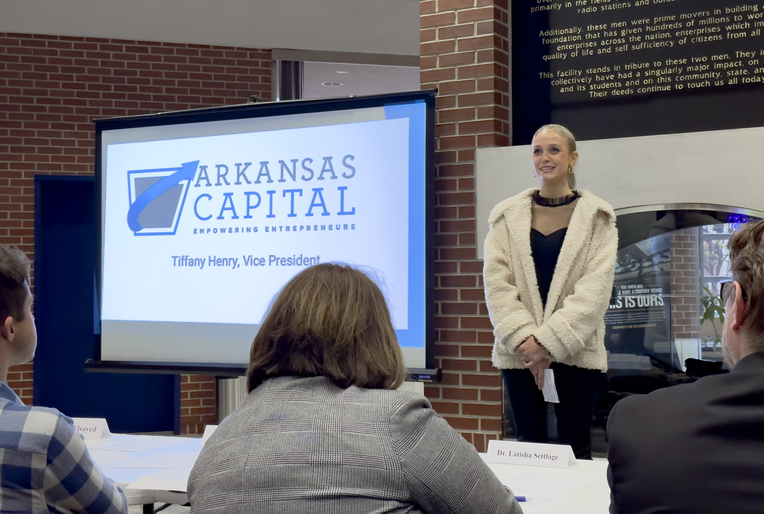 a woman presents her business plan at the UAFS Lions Lair event
