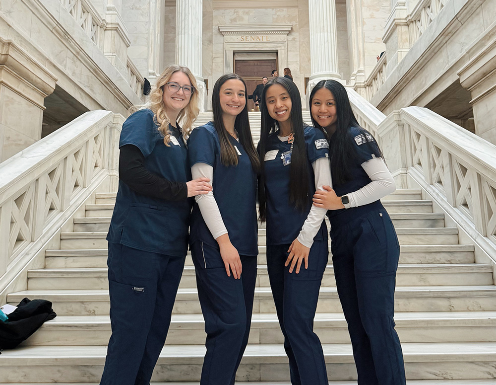 Four UAFS nursing students stand on the steps inside of the Arkansas Capitol during the 2025 Nurses Day at the Capitol event.