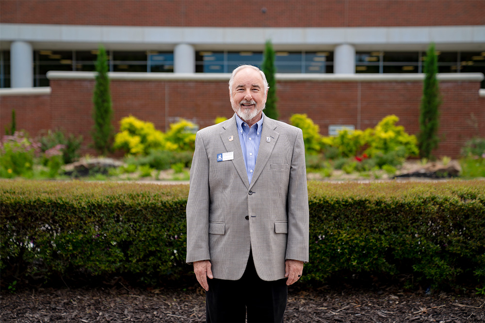 Dr. Randle Overbey stands outside of the Baldor Building at UAFS.