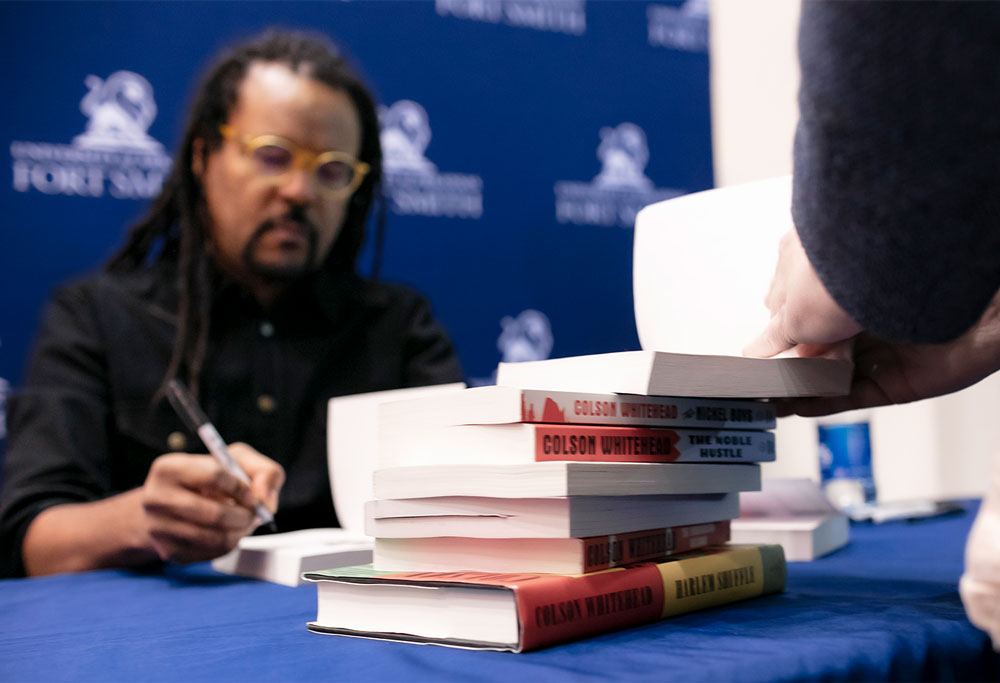 Author, Colson Whitehead, signs copies of his books following a guest-speaking event at UAFS