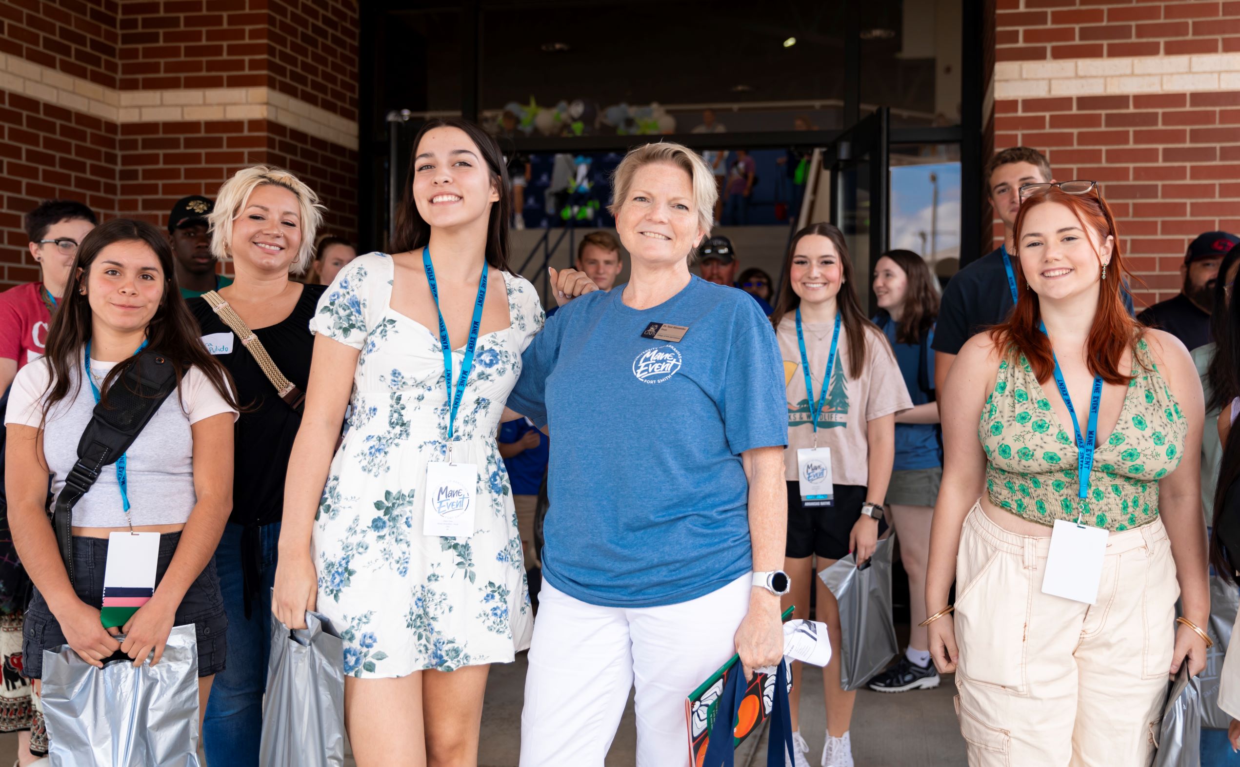 New female dean surrounded by students