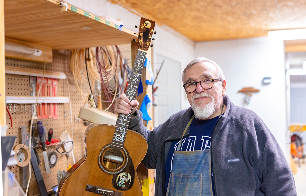 Dr. Dennis Siler shows off his custom Harry Potter inspired guitar inside his workshop. 