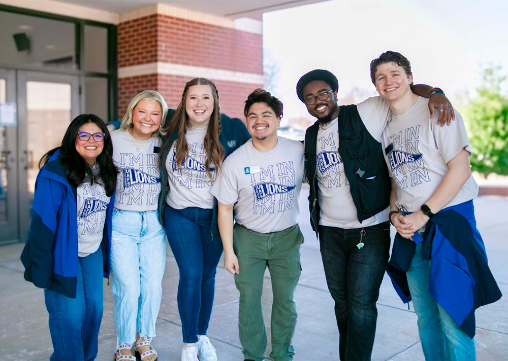 Members of the UAFS Admissions Team smile in front of the Stubblefield Center at the University of Arkansas - Fort Smith