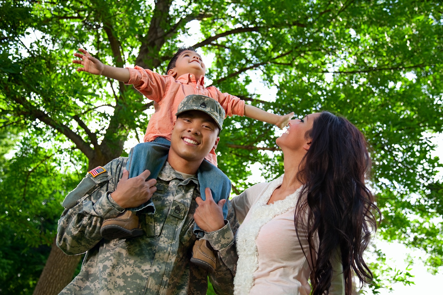 a veteran family embraces at the park